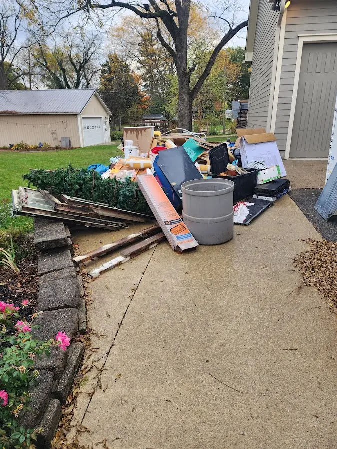 Dumpster being loaded with debris for Estate Cleanout Dumpster Rental in Groveton